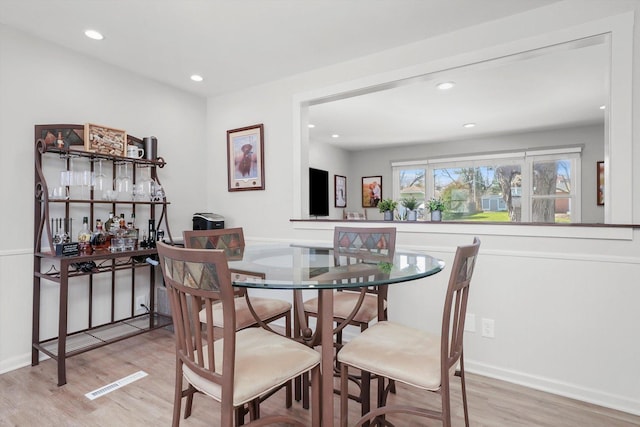 dining space with recessed lighting, light wood-style flooring, and visible vents