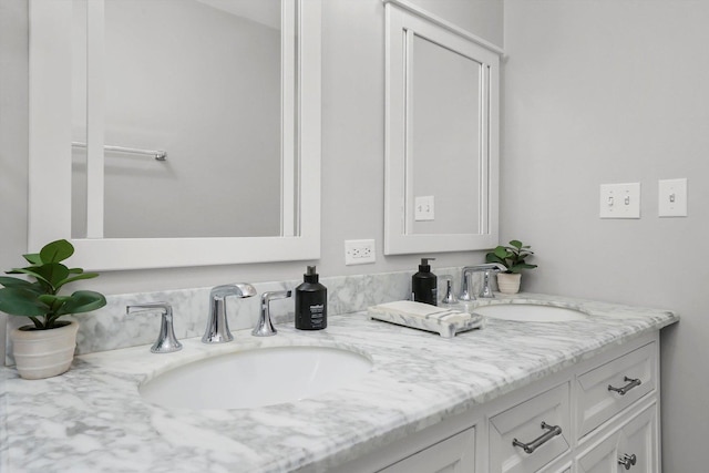 full bathroom with double vanity and a sink