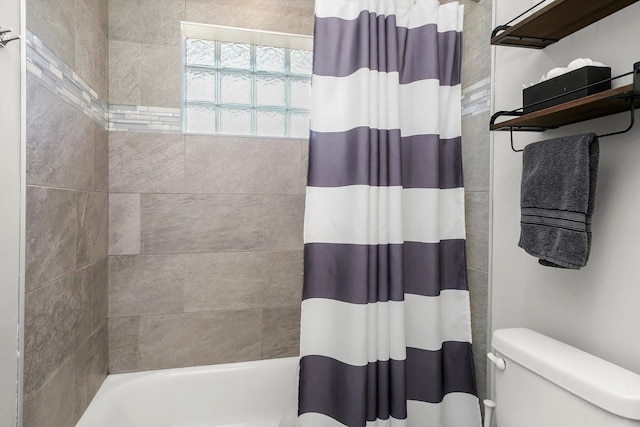 bathroom with shower / tub combo and toilet