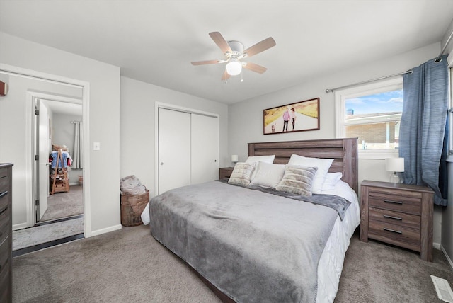 bedroom featuring a closet, baseboards, a ceiling fan, and carpet