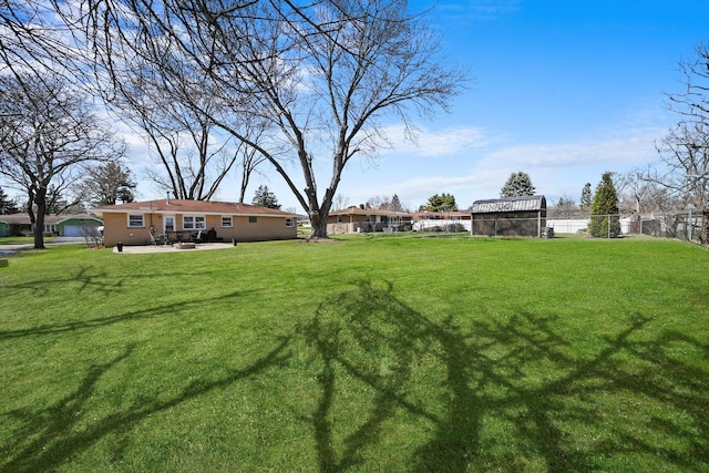 view of yard featuring a patio area and fence