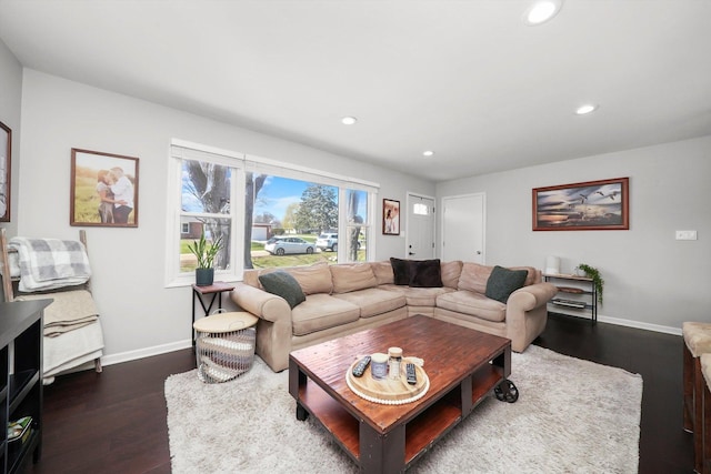 living room featuring dark wood-type flooring, baseboards, and recessed lighting