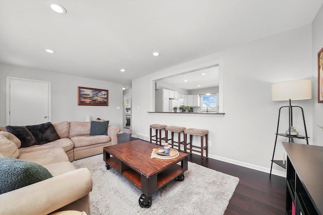living room featuring recessed lighting, baseboards, and dark wood finished floors