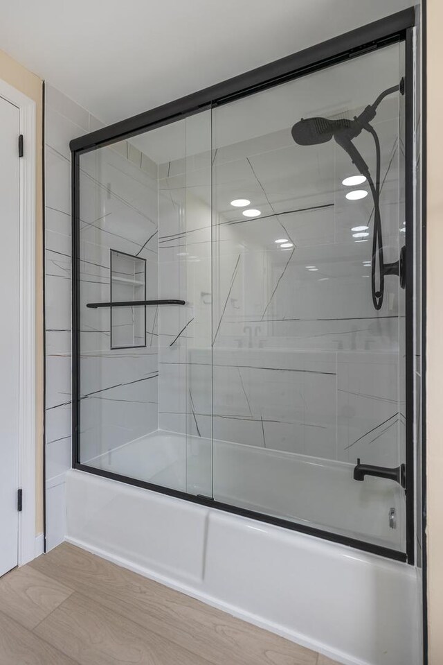 bathroom featuring shower / bath combination with glass door