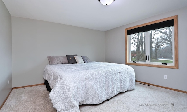 carpeted bedroom featuring visible vents and baseboards