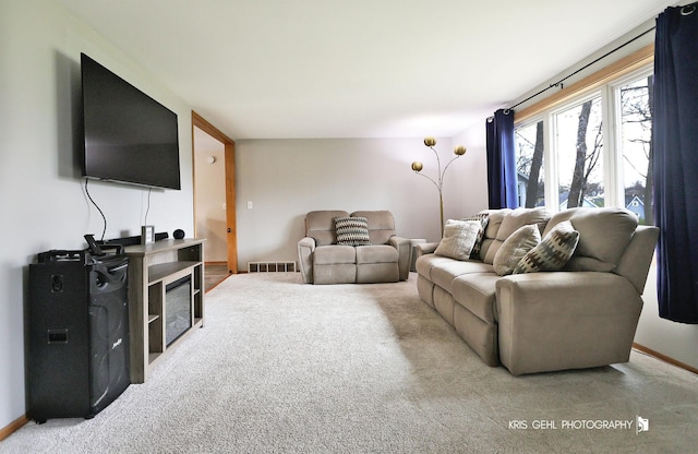 carpeted living area with baseboards and visible vents