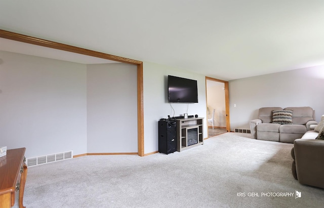 living area featuring baseboards, carpet, and visible vents