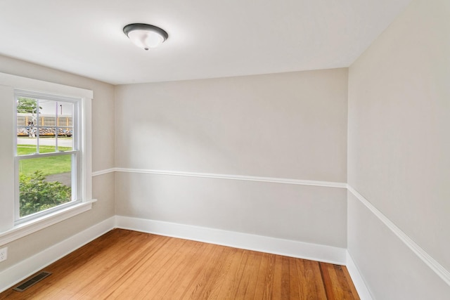 bonus room featuring baseboards, wood finished floors, and vaulted ceiling