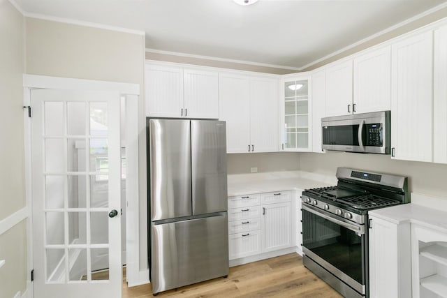 kitchen featuring white cabinetry, stainless steel appliances, and light countertops