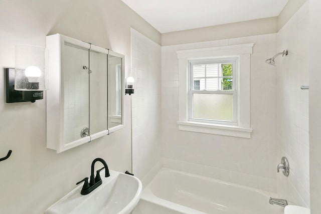 full bathroom featuring washtub / shower combination and a sink