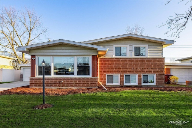 188 W Normandy Dr, Chicago Heights, IL 60411 - split level home with brick siding, a front yard, and a garage