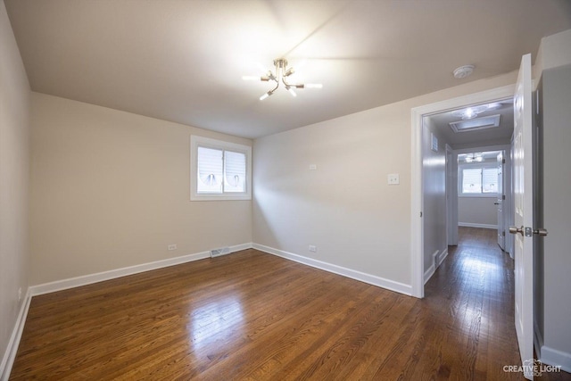 188 W Normandy Dr, Chicago Heights, IL 60411 - unfurnished room with dark wood-style flooring, baseboards, and a chandelier