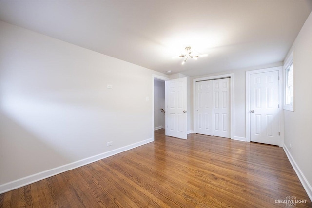188 W Normandy Dr, Chicago Heights, IL 60411 - unfurnished bedroom with a chandelier, baseboards, and wood finished floors