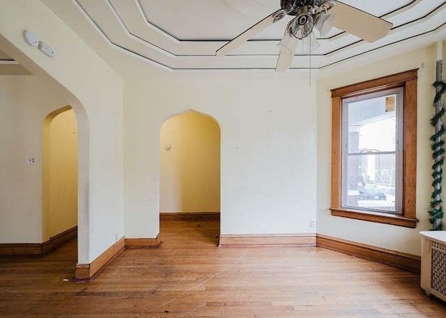 1228 S 59th Ave, Cicero, IL 60804 - empty room featuring baseboards, arched walkways, light wood-style floors, and ceiling fan