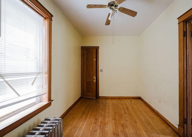 1228 S 59th Ave, Cicero, IL 60804 - spare room featuring radiator, baseboards, a ceiling fan, and light wood-type flooring