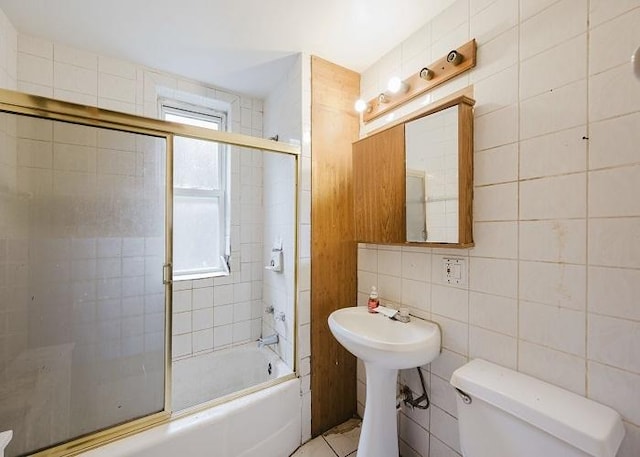 1228 S 59th Ave, Cicero, IL 60804 - full bathroom with plenty of natural light, combined bath / shower with glass door, toilet, and tile walls