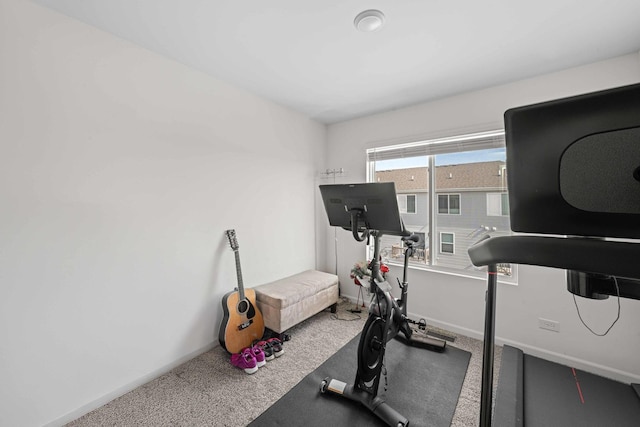 workout room with carpet floors and baseboards