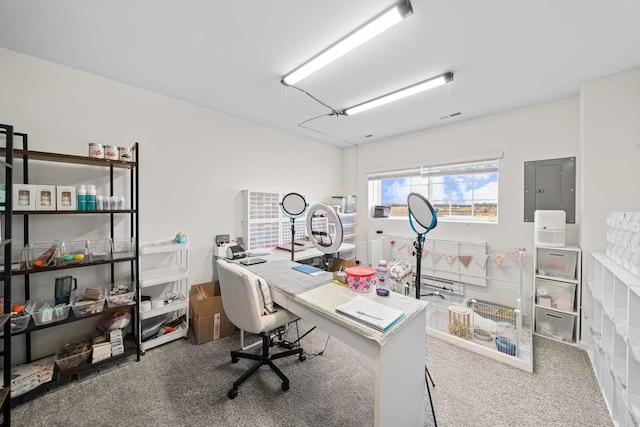 office featuring visible vents, carpet flooring, and electric panel