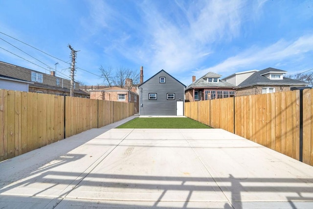 exterior space with an outbuilding and a fenced backyard
