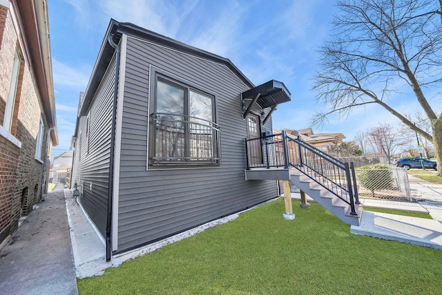 view of home's exterior featuring a yard and fence