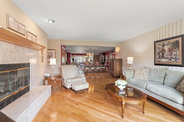 5 Saint Moritz Dr Unit 101, Palos Park, IL 60464 - living area with a fireplace, wallpapered walls, wood finished floors, and a chandelier
