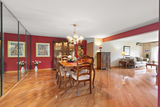 5 Saint Moritz Dr Unit 101, Palos Park, IL 60464 - dining area with light wood-type flooring, a chandelier, and baseboards