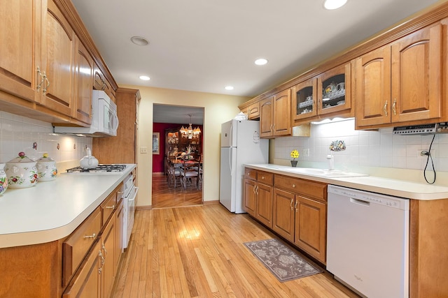 5 Saint Moritz Dr Unit 101, Palos Park, IL 60464 - kitchen featuring white appliances, decorative backsplash, brown cabinets, a sink, and recessed lighting