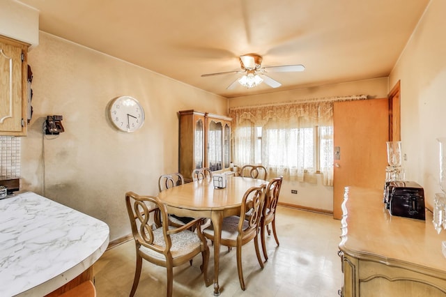 dining area with baseboards and a ceiling fan