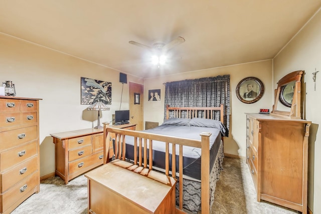 bedroom featuring light colored carpet and a ceiling fan