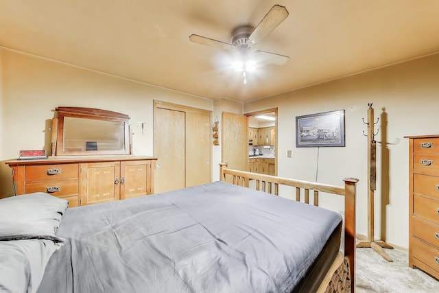 bedroom with light carpet, ceiling fan, and ensuite bathroom