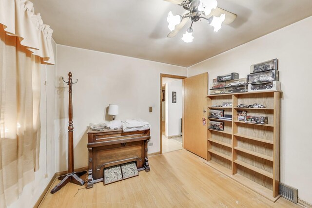 office area featuring visible vents, an inviting chandelier, and wood finished floors