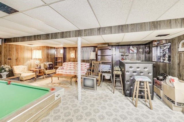 rec room featuring wood walls, billiards, a paneled ceiling, and a bar