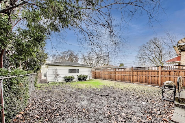 view of yard featuring an outbuilding and a fenced backyard