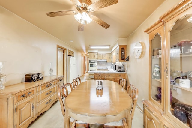 dining room featuring a toaster, light tile patterned floors, and a ceiling fan
