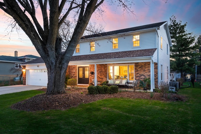 69 S Parkway Dr, Naperville, IL 60540 - traditional home featuring a lawn, an attached garage, driveway, and covered porch