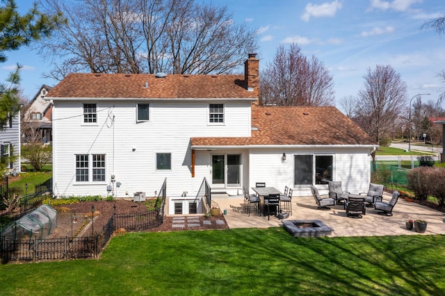 69 S Parkway Dr, Naperville, IL 60540 - back of property with fence, an outdoor living space with a fire pit, a chimney, a patio, and a yard