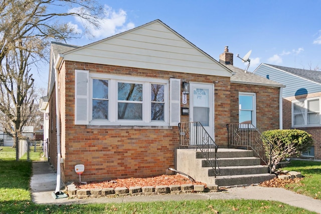 330 Paxton Ave, Calumet City, IL 60409 - bungalow featuring a gate, roof with shingles, a chimney, fence, and brick siding