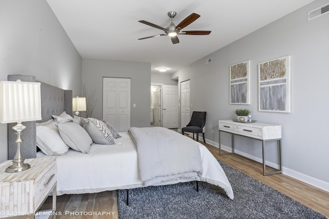 8400 Callie Ave Unit 402, Morton Grove, IL 60053 - bedroom featuring baseboards, visible vents, wood finished floors, and multiple closets