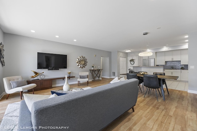 8400 Callie Ave Unit 402, Morton Grove, IL 60053 - living area featuring baseboards, recessed lighting, and light wood-style flooring