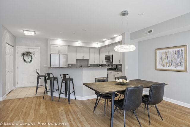 8400 Callie Ave Unit 402, Morton Grove, IL 60053 - dining space featuring visible vents, light wood-style flooring, and baseboards
