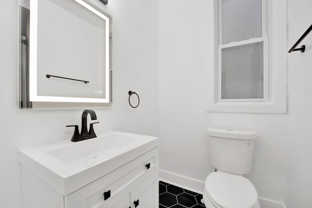 2134 W Shakespeare Ave, Chicago, IL 60647 - half bathroom with toilet, vanity, tile patterned floors, and baseboards
