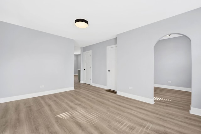 2134 W Shakespeare Ave, Chicago, IL 60647 - empty room with baseboards, wood finished floors, and arched walkways