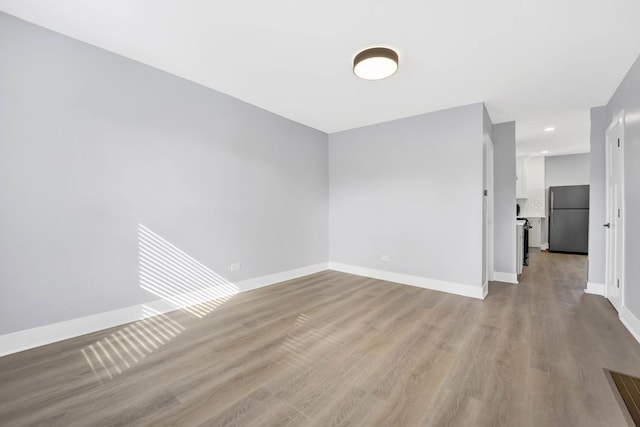 2134 W Shakespeare Ave, Chicago, IL 60647 - spare room featuring baseboards, light wood-style floors, and recessed lighting