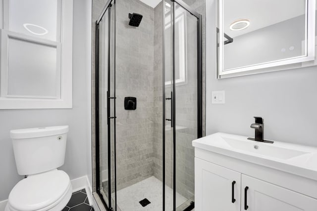 2134 W Shakespeare Ave, Chicago, IL 60647 - bathroom featuring baseboards, toilet, a stall shower, and vanity