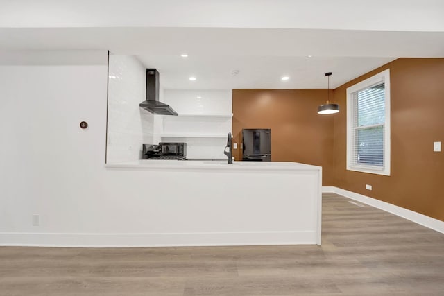 2134 W Shakespeare Ave, Chicago, IL 60647 - kitchen featuring light wood finished floors, wall chimney exhaust hood, a peninsula, baseboards, and recessed lighting