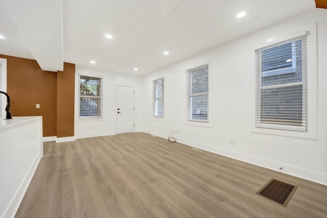 2134 W Shakespeare Ave, Chicago, IL 60647 - unfurnished living room featuring recessed lighting, baseboards, light wood-style floors, and visible vents