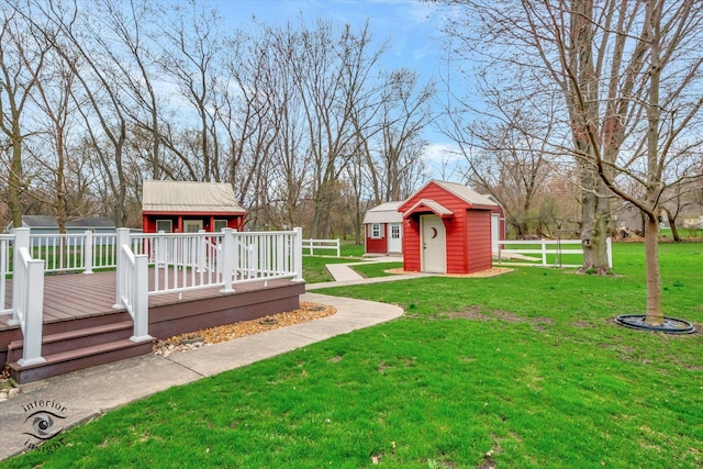 274 N School St, Braidwood, IL 60408 - view of yard featuring a wooden deck, fence, and an outbuilding