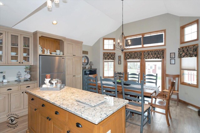 274 N School St, Braidwood, IL 60408 - kitchen with light wood finished floors, freestanding refrigerator, light stone counters, and lofted ceiling