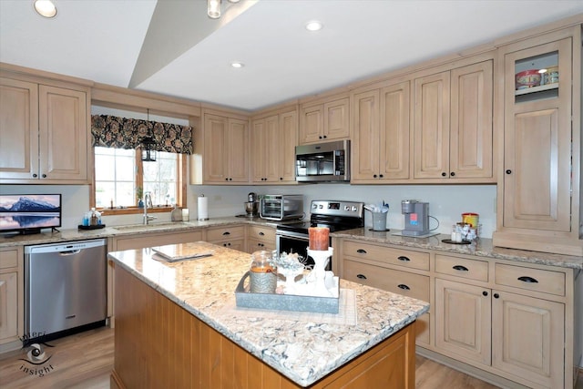274 N School St, Braidwood, IL 60408 - kitchen with a sink, light wood-type flooring, stainless steel appliances, cream cabinets, and a kitchen island