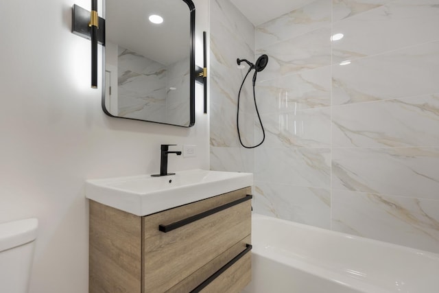 bathroom with toilet, vanity, and washtub / shower combination